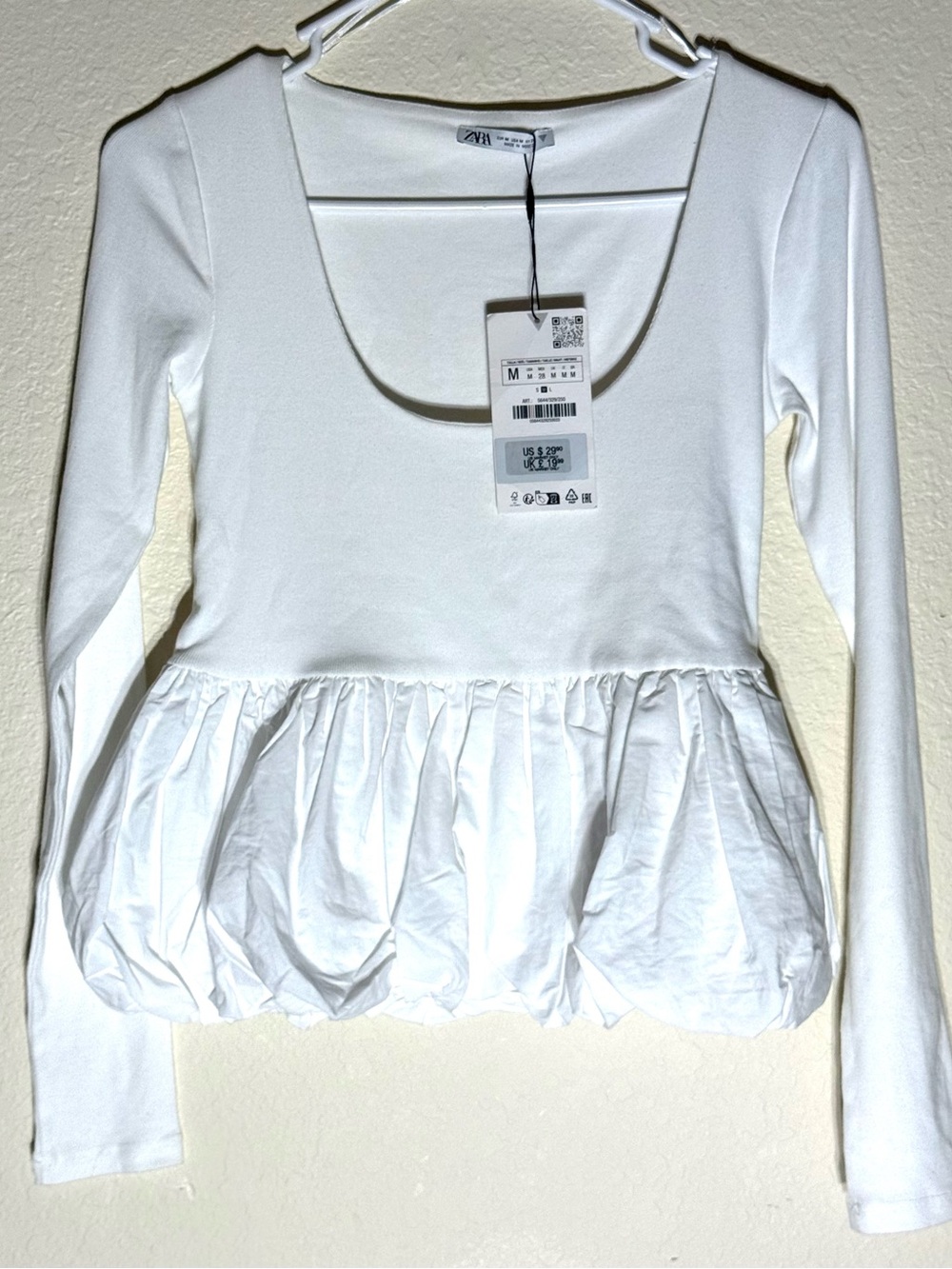 New Zara white long sleeve top with ruffled peplum hem. Soft fabric.